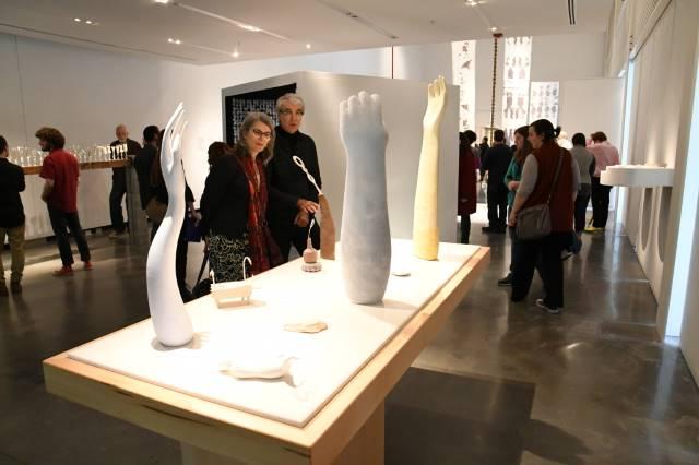 People viewing art on display at a student show